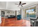 Open-concept living room boasts hardwood floors, modern decor, and a sliding glass door to the balcony at 345 Bayshore Blvd # 308, Tampa, FL 33606