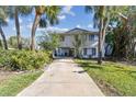 Two-story home with a driveway and lush landscaping at 4675 Chancellor Ne Cir, St Petersburg, FL 33703