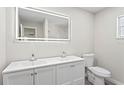 Bright bathroom with a double sink vanity, illuminated mirror, and a separate shower area at 615 W Virginia Ave, Tampa, FL 33603