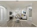 Open-concept living room with hardwood floors that connect to the kitchen and dining areas at 615 W Virginia Ave, Tampa, FL 33603