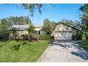 Well-maintained one-story home boasting a two-car garage, green lawn, and mature landscaping at 7255 18Th Ne St, St Petersburg, FL 33702