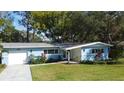 Ranch style home with a modern facade and landscaping at 1042 Idlewild N Dr, Dunedin, FL 34698