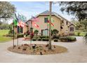 Inviting single Gathering home featuring a circular drive and beautiful, well maintained landscaping at 12709 Mannhurst Oak Ln, Lithia, FL 33547