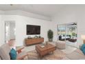 Bright living room with access to a screened porch at 13229 Golf Ridge Pl, Hudson, FL 34669
