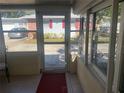 Cozy screened porch with tile flooring, and access to backyard at 1601 Berwick Ct # B, Palm Harbor, FL 34684