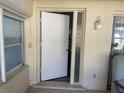 Front entry with a white door and glass sidelights at 1601 Berwick Ct # B, Palm Harbor, FL 34684