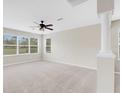 Bright living room with large windows and ceiling fan at 30619 White Bird Ave, Wesley Chapel, FL 33543