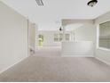 Spacious living room with neutral carpeting and high ceilings at 30619 White Bird Ave, Wesley Chapel, FL 33543