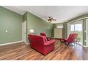 Living room with red leather furniture and wood flooring at 3607 E Bay Dr # 211, Holmes Beach, FL 34217