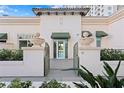 Charming gated entrance with stone columns and green awnings lead to a serene living space at 450 Knights Run Ave # 407, Tampa, FL 33602