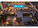 Stunning aerial view of a luxury condo complex showcasing a pool and lush outdoor lounge area at 450 Knights Run Ave # 407, Tampa, FL 33602