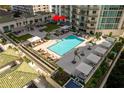 Luxury condo complex featuring a beautiful swimming pool, cabanas, and outdoor lounge spaces at 450 Knights Run Ave # 407, Tampa, FL 33602