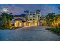 Luxury building with gated entrance and paved driveway, beautifully lit at night at 455 Pinellas Bayway S # 4A, Tierra Verde, FL 33715