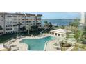 Resort-style pool with patio furniture, offering a relaxing waterfront view at 632 Edgewater Dr # 532, Dunedin, FL 34698