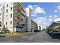 Condo building side view showing parking and landscaping at 8198 Terrace Garden N Dr # 403, St Petersburg, FL 33709