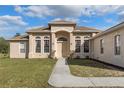 House exterior featuring a light-brown color and walkway at 11004 Carnes St, Weeki Wachee, FL 34613