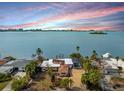 Aerial view of waterfront property showcasing expansive water views at sunset at 1840 Venetian Point Dr, Clearwater, FL 33755