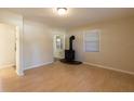 Bright living room featuring hardwood floors and a wood-burning stove at 2415 Durant Rd, Valrico, FL 33596