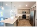 Modern kitchen with gray cabinets, quartz countertops, and stainless steel appliances at 25434 Colon Dr, Punta Gorda, FL 33983