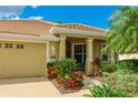 One-story home with a covered entryway and attractive landscaping at 2681 Whispering Pine Ln, North Port, FL 34287