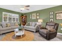 Comfortable living room with light gray sofas and a recliner at 2939 Yucca Ct, Palm Harbor, FL 34684