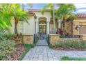 House exterior featuring a charming walkway and decorative gate at 4907 Londonderry Dr, Tampa, FL 33647