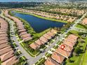 An aerial view showcases the community with a serene lake and lush green spaces at 5721 Sunset Falls Dr, Apollo Beach, FL 33572