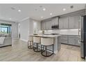 Modern kitchen with gray cabinets, white quartz counters and stainless steel appliances at 5810 Silver Sun Dr, Apollo Beach, FL 33572