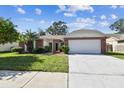 Brick ranch-style home with a two-car garage at 8910 Beeler Dr, Tampa, FL 33626