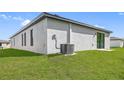 Rear view of a single-Gathering home with grassy backyard at 29502 Fedora Cir, Brooksville, FL 34602