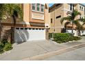 Attached garage with white door and ample parking space at 562 Rivercrest Ln, Tarpon Springs, FL 34689