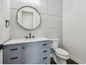 Modern powder room with a gray vanity and white toilet at 3829 71St N St, St Petersburg, FL 33709