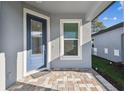 Cozy covered front porch featuring a stylish blue front door with glass details at 9462 Shorebird Ct, Parrish, FL 34219