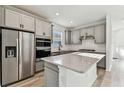Modern kitchen boasts stainless steel appliances, gray cabinets, and quartz countertops at 9462 Shorebird Ct, Parrish, FL 34219