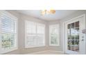 Bright breakfast nook with white shutters and access to a screened porch at 10230 Old Tampa Bay Dr, San Antonio, FL 33576