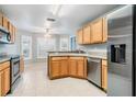 Kitchen features stainless steel appliances and light wood cabinets at 10230 Old Tampa Bay Dr, San Antonio, FL 33576