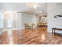 Spacious living room with hardwood floors and a view into the dining area at 10230 Old Tampa Bay Dr, San Antonio, FL 33576