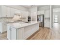 Stylish kitchen featuring white cabinets, stainless steel appliances, spacious countertops, and island at 11477 Waterway Dr, Parrish, FL 34219