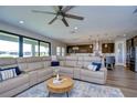 Spacious living room featuring a large sectional sofa and a modern coffee table at 12735 Bergstrom Bay Dr, Riverview, FL 33579