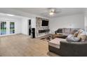 Spacious living room with L-shaped sectional sofa and stone accent wall at 12905 N Oregon Ave, Tampa, FL 33612