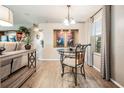 Small dining area with round glass-top table and two chairs at 37652 New Horizons Blvd, Zephyrhills, FL 33541