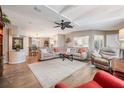 Spacious living room with large sectional sofa and wood-look flooring at 37652 New Horizons Blvd, Zephyrhills, FL 33541
