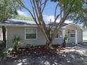 House exterior, gray siding, landscaping, and tree in front at 4201 Dr Martin Luther King Jr N St, St Petersburg, FL 33703