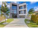 Modern two-story home with a sleek design and spacious driveway at 448 22Nd St, Belleair Beach, FL 33786