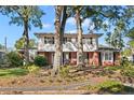 Two-story house with brick and shingle exterior, surrounded by trees at 4801 Dartmouth N Ave, St Petersburg, FL 33713