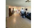 Spacious living room with tiled floors and ample natural light at 8906 Windsong Ln, Port Richey, FL 34668