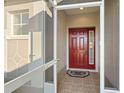 Inviting front entry with a red door and tiled flooring at 10306 Chatuge Dr, San Antonio, FL 33576