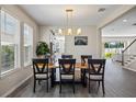 Dining area with a live-edge wood table and modern chairs at 10551 Tranquil Meadow Loop, Riverview, FL 33569