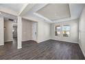 Open living area with wood-look tile flooring and neutral walls at 10551 Tranquil Meadow Loop, Riverview, FL 33569