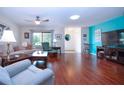 Living room showcasing hardwood floors, comfortable seating, and a large TV at 1623 Faxton Dr, Sun City Center, FL 33573